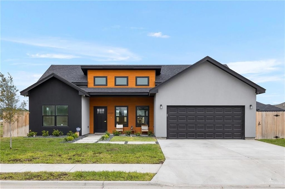 View of front of home with a garage and a front yard