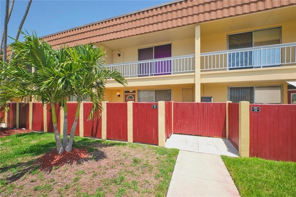View of building exterior with a fenced front yard