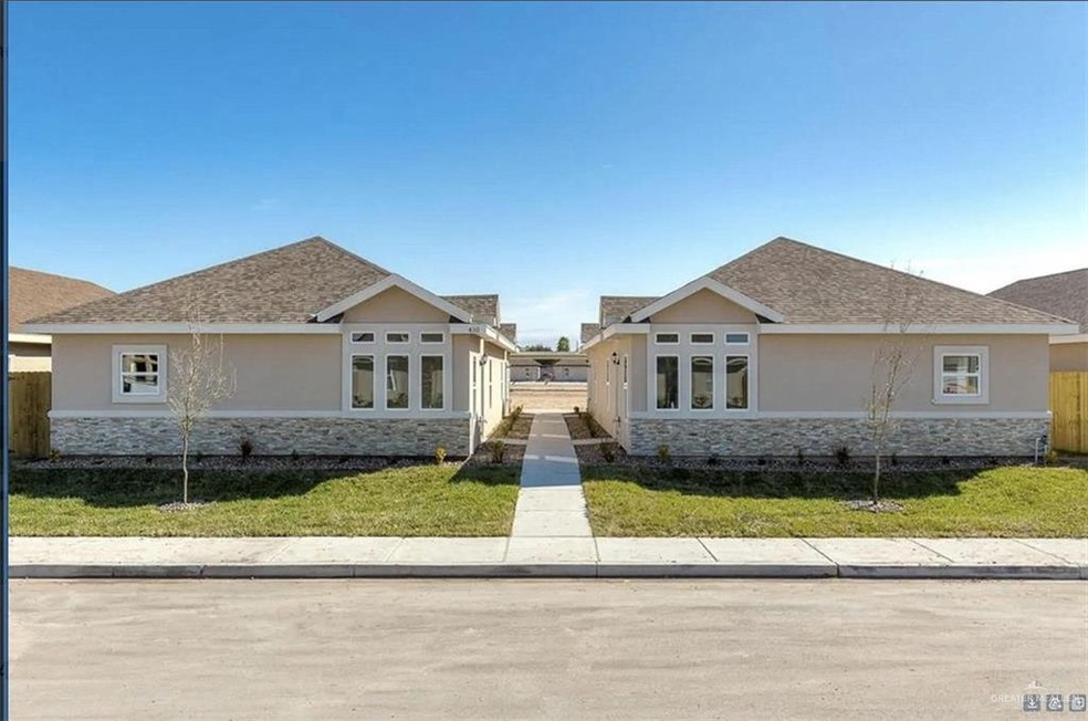 View of front facade featuring stone siding, stucco siding, and roof with shingles