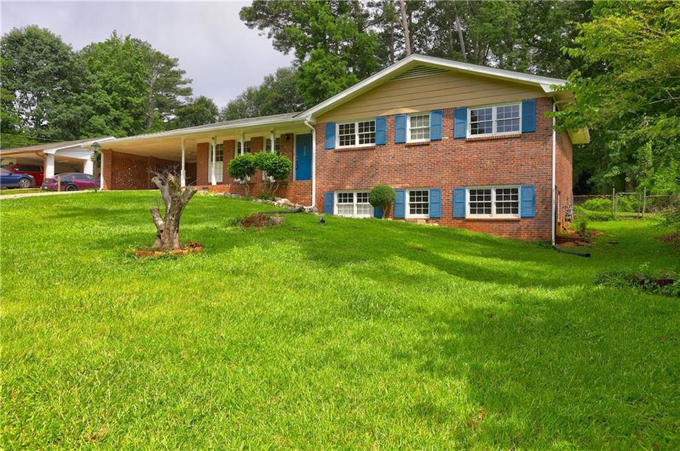 Ranch-style home featuring a carport and brick siding