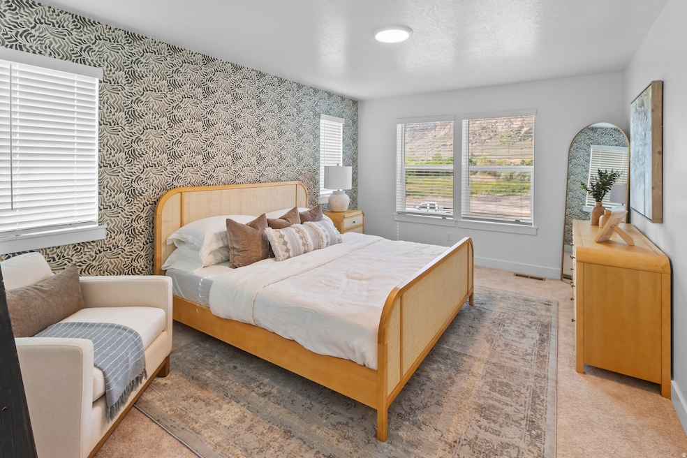 Carpeted bedroom featuring wallpapered walls