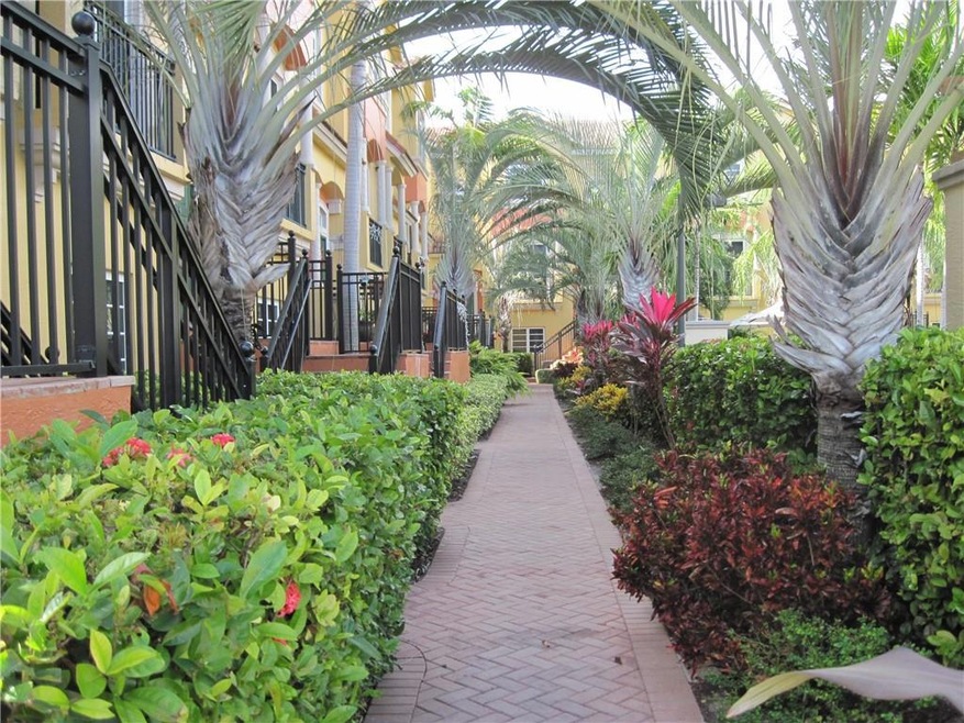 Beautiful paved sidewalk and tropical landscaping as you approach your new home.