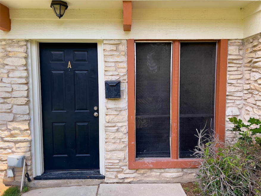 View of exterior entry with stone siding