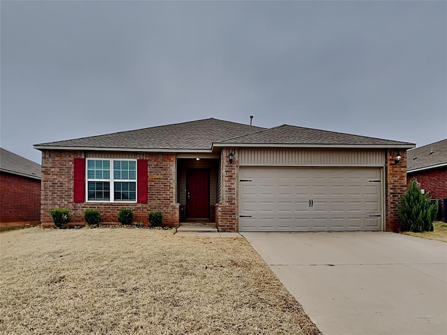 Ranch-style house featuring brick siding, an attached garage, driveway, and a shingled roof
