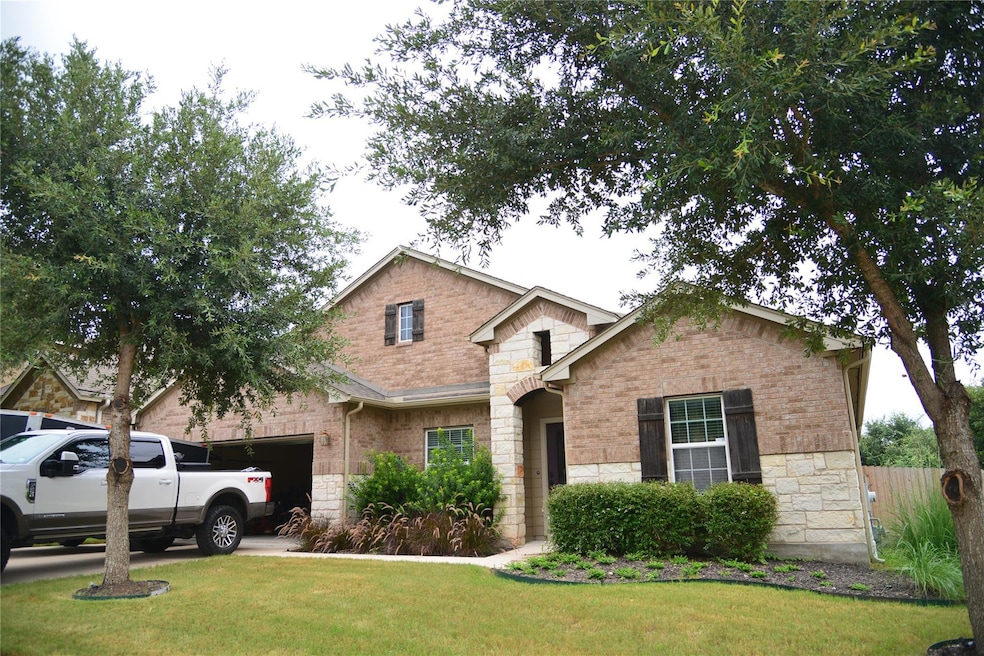 View of front of house featuring stone siding, a 