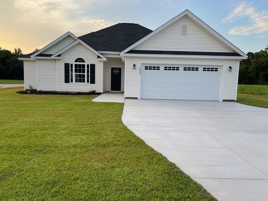 View of front of house with a garage and a lawn