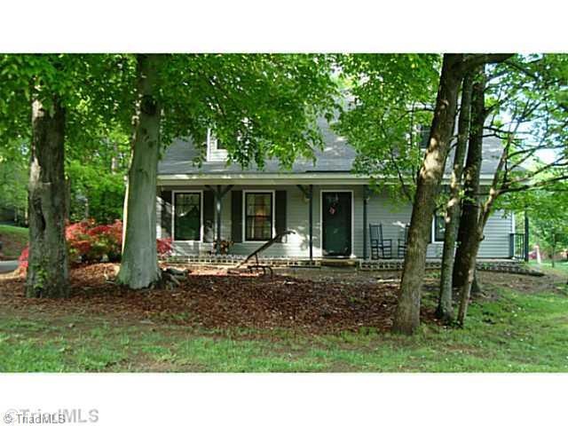 Exterior Front. Attractive vinyl sided home sits on a large tree shaded corner lot.