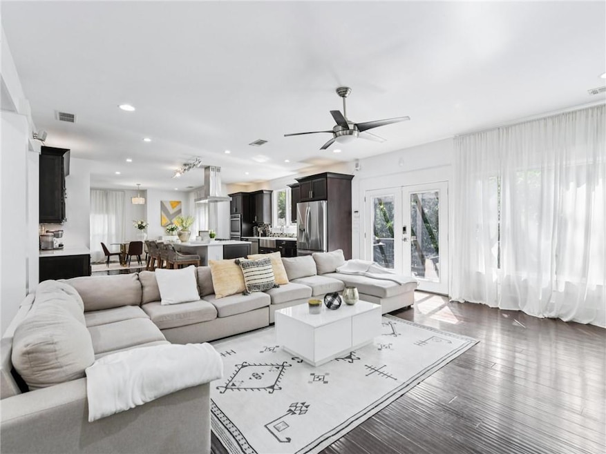 Living area featuring french doors, recessed lighting, wood finished floors, and ceiling fan