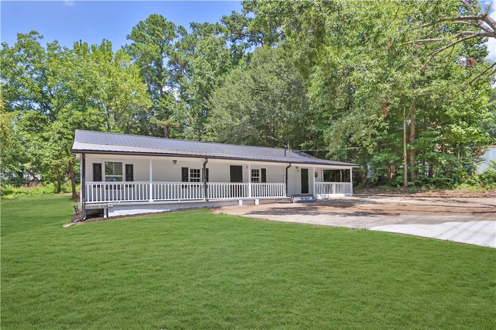 Ranch-style house featuring a porch and a front ya