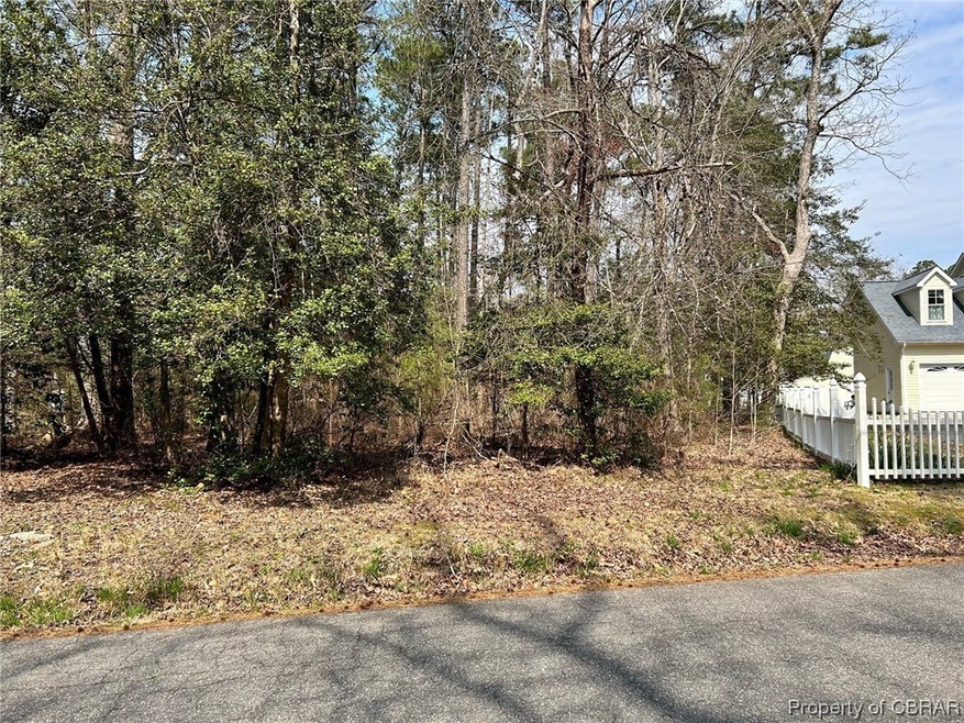 Parcel to left of white fence.