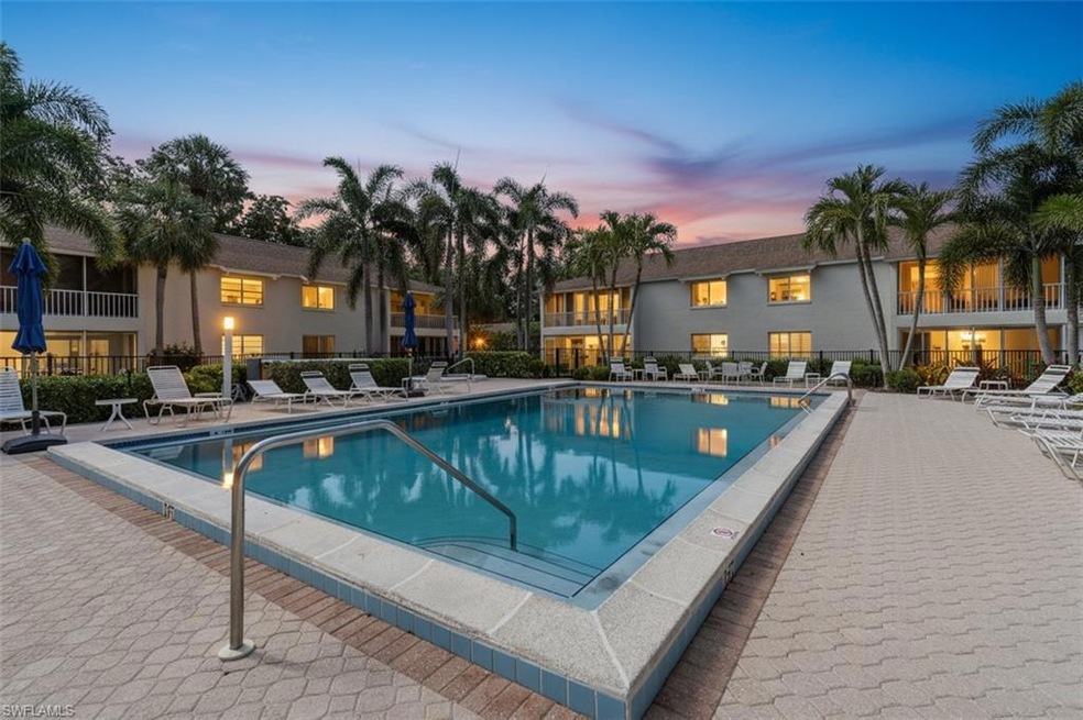 Pool at dusk featuring a patio area and a community pool