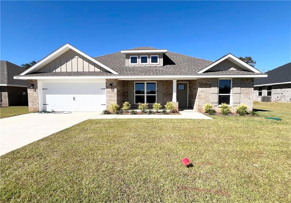Craftsman-style home with brick siding, a porch, a front yard, and roof with shingles