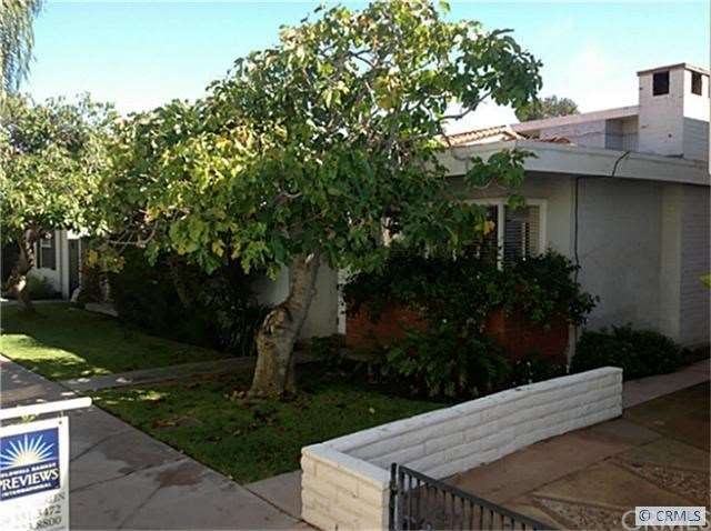The house faces a tree shaded strada.