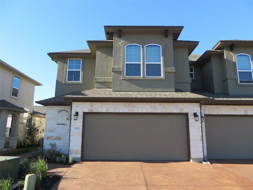 View of front of home featuring a garage, stucco 