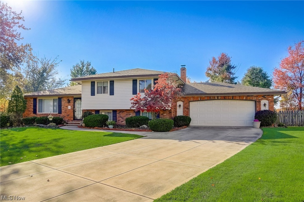 Split level home featuring a garage and a front yard