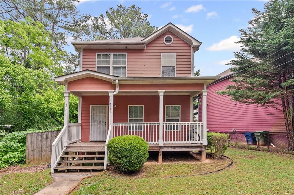 Traditional home featuring covered porch, fence, a