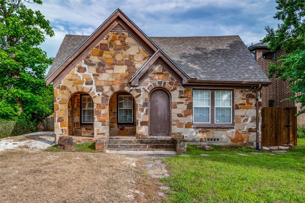 Tudor-style house with a front yard