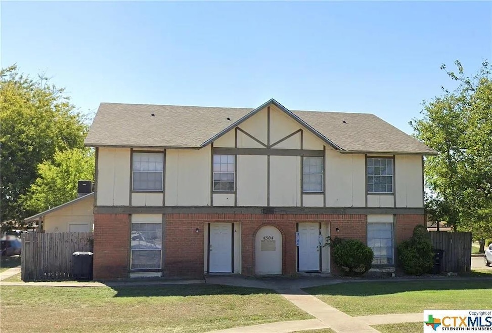 View of front of home featuring brick siding and 