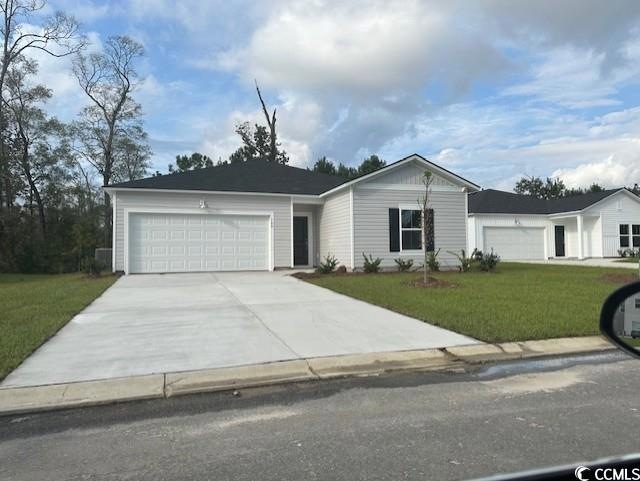 Single story home featuring a garage and a front l