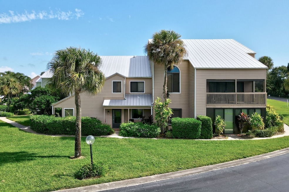 Mid-century inspired home featuring a front lawn, a metal roof, and a porch