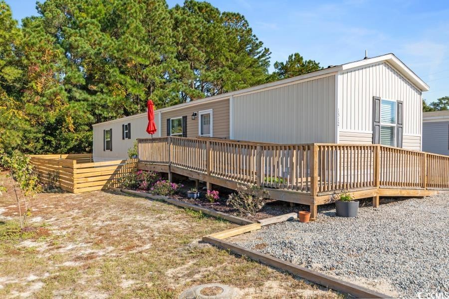View of front of home featuring a wooden deck
