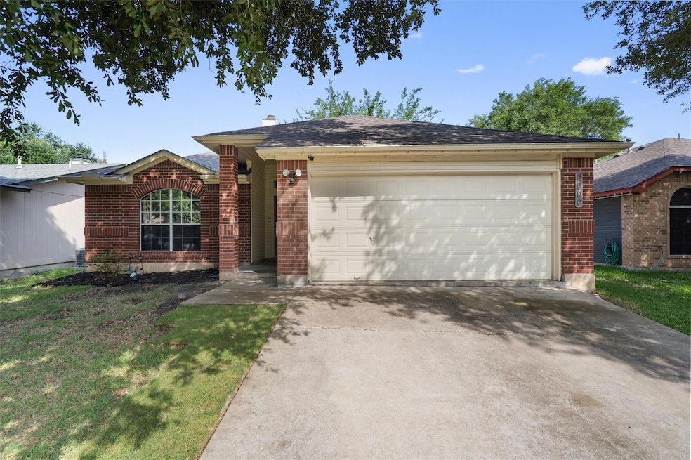 Ranch-style home with brick siding, an attached g