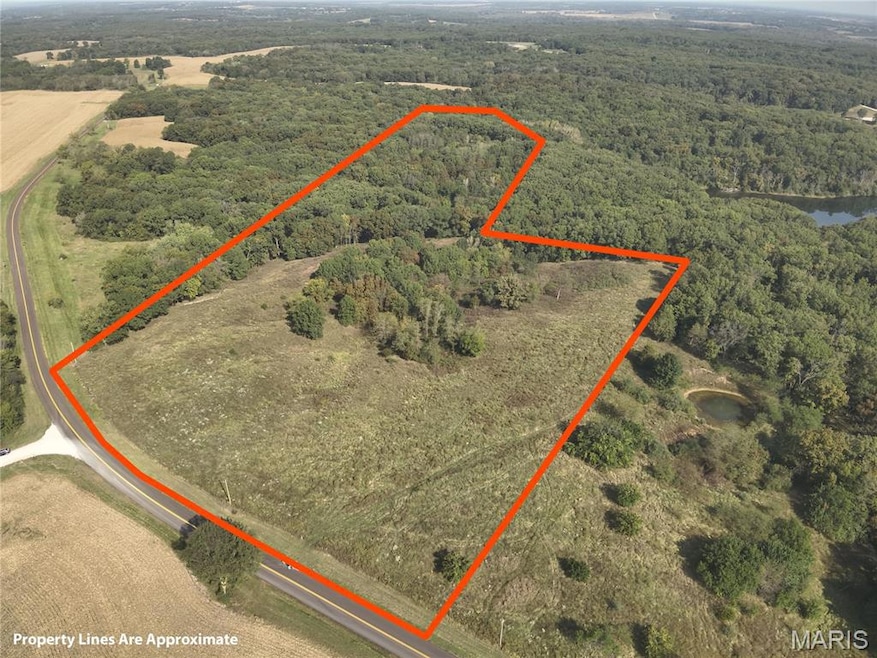 Aerial view of sparsely populated area with property parcel outlined