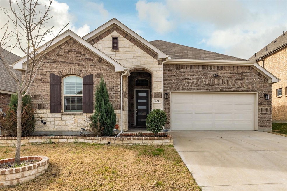 French country style house with brick siding, a sh