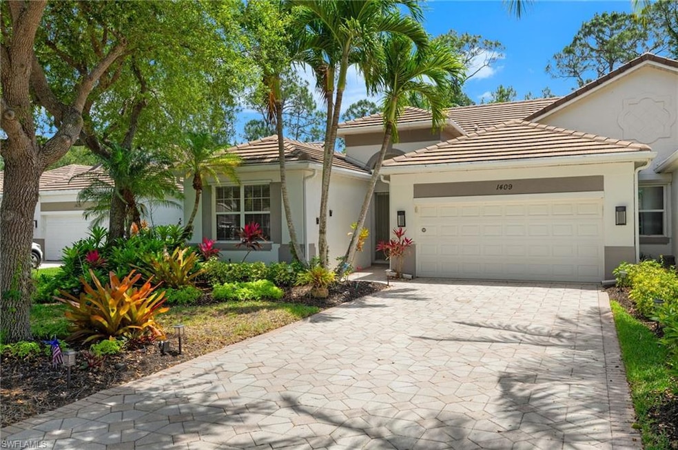 View of front of house featuring a tiled roof, an 