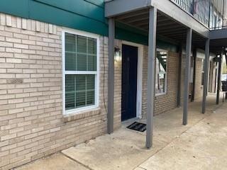 View of exterior entry featuring a balcony