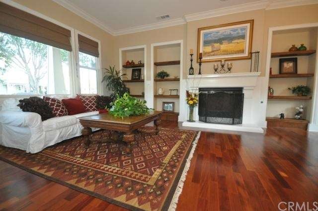 Living room features fireplace and warm wood floor