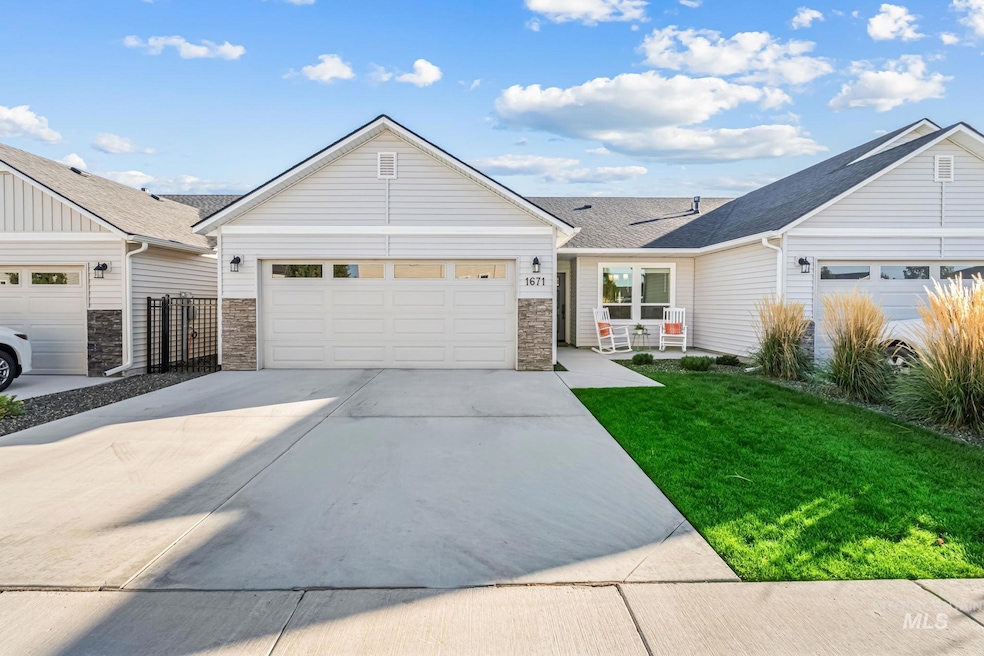 Ranch-style home with concrete driveway, stone siding, a shingled roof, a front lawn, and a garage