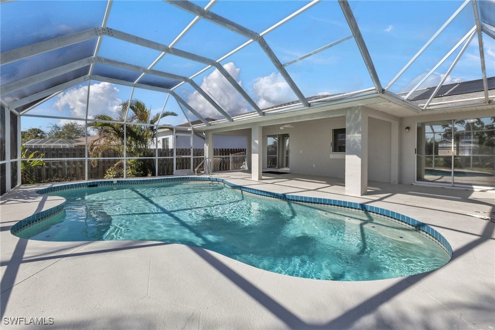View of swimming pool featuring glass enclosure, c