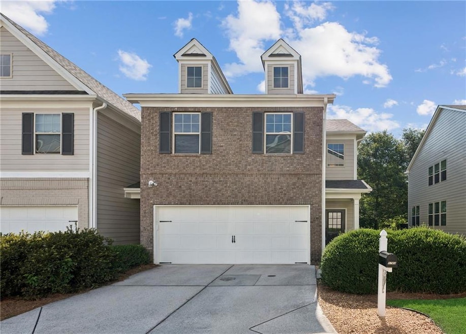 Traditional home with concrete driveway, brick siding, and a garage