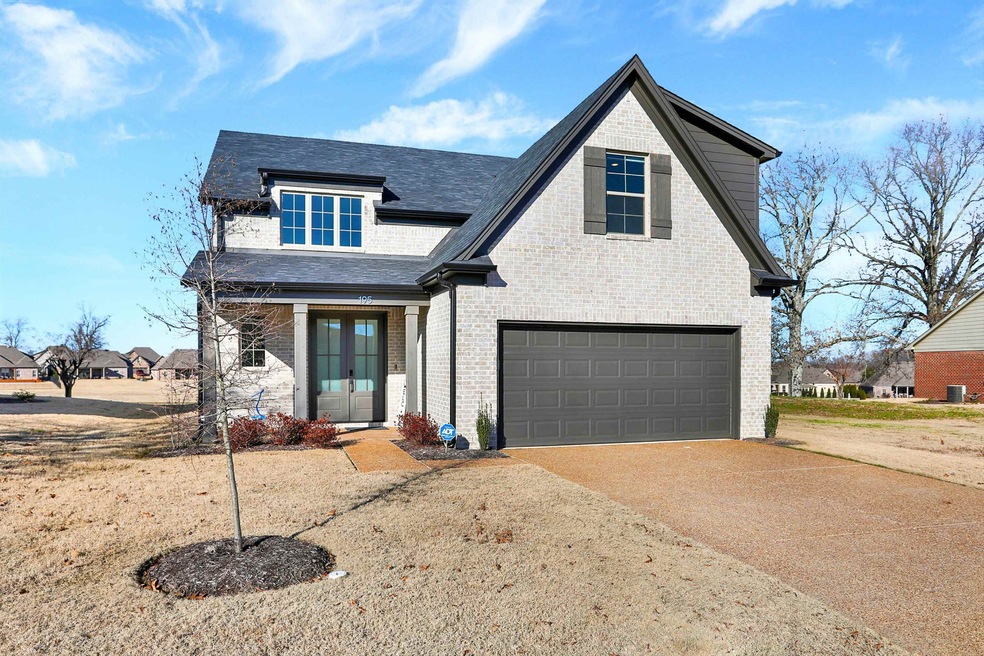 View of front facade with french doors and a garage