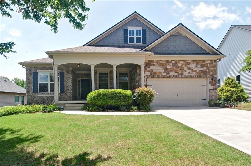 Craftsman-style home featuring a front yard, concr