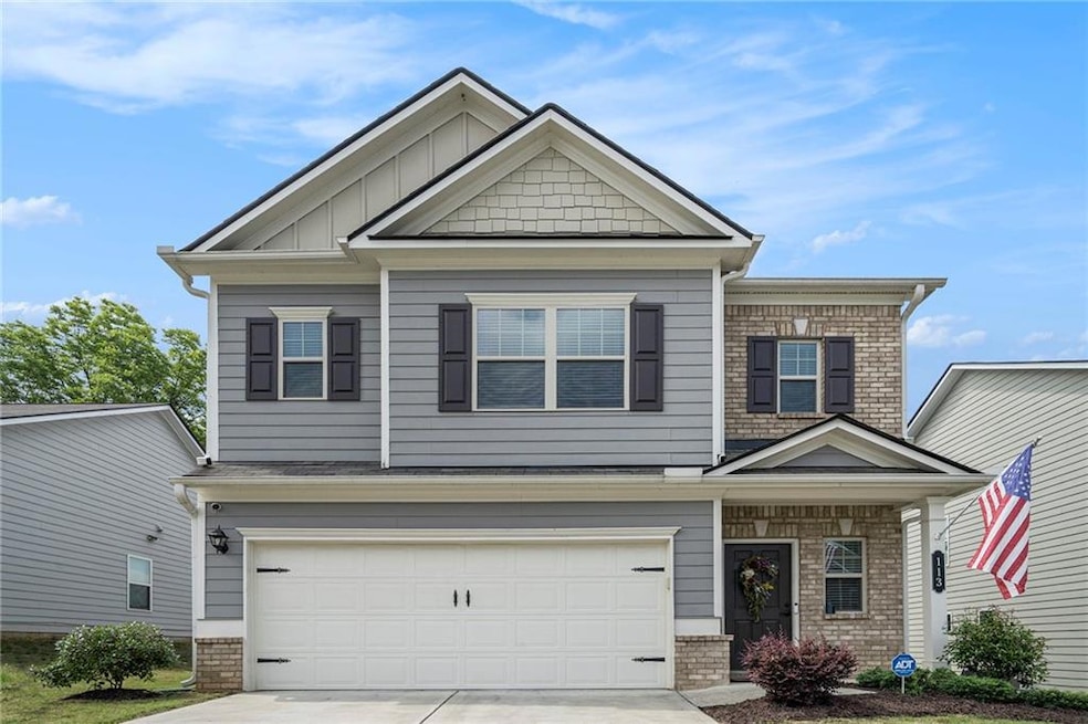 Craftsman-style house featuring driveway, a garage, and brick siding