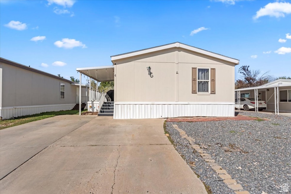 View of side of property featuring concrete driveway