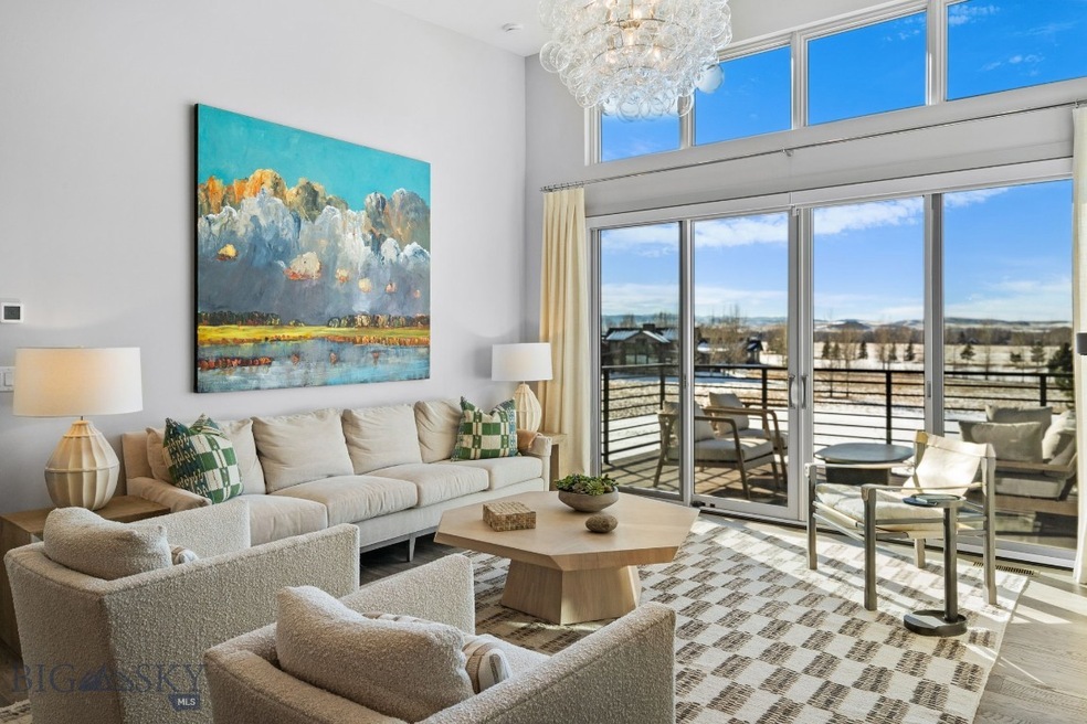 Living room with 15 ft ceilings, glass slider to b