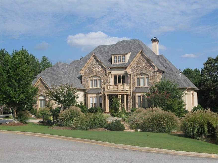 French country style house with stone siding, a ba