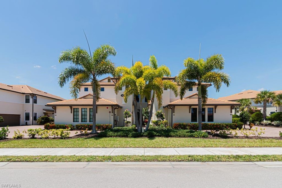 View of front of property featuring stucco siding and a front lawn