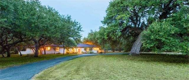 One story home on 3.843 acres with a 450 year old oak in the front yard.
