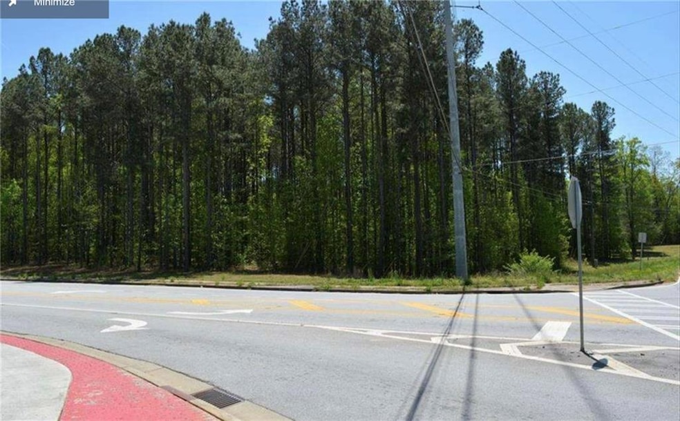 View of asphalt road featuring traffic signs and curbs