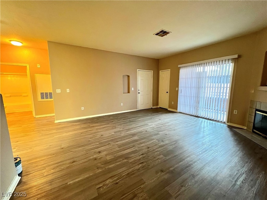Unfurnished living room featuring a fireplace, woo
