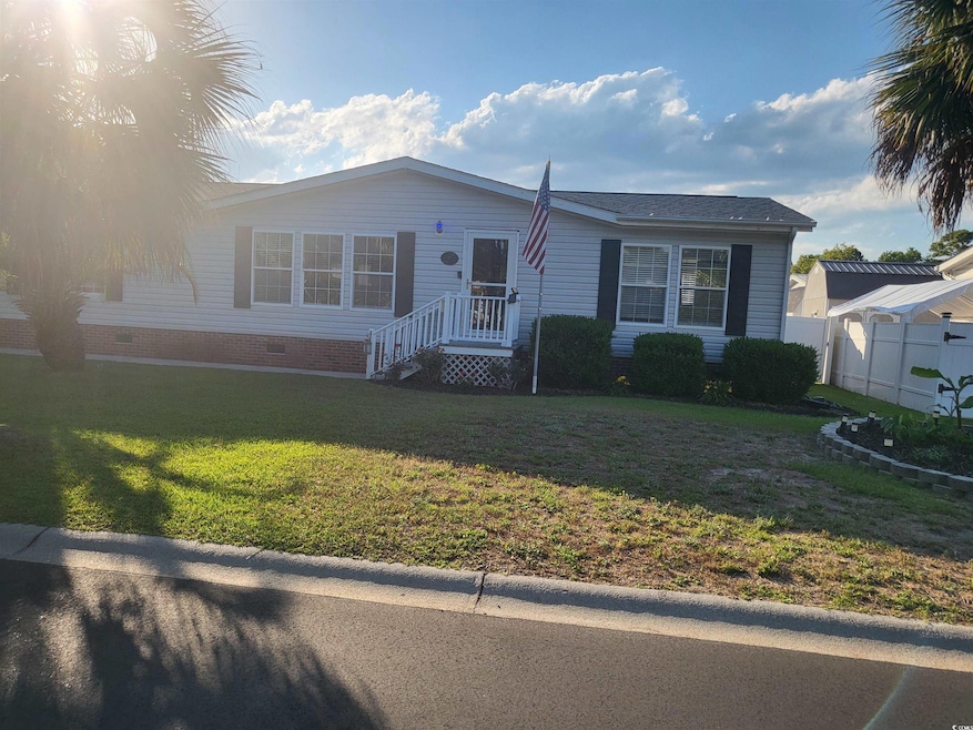 View of front of house with crawl space, fence, an