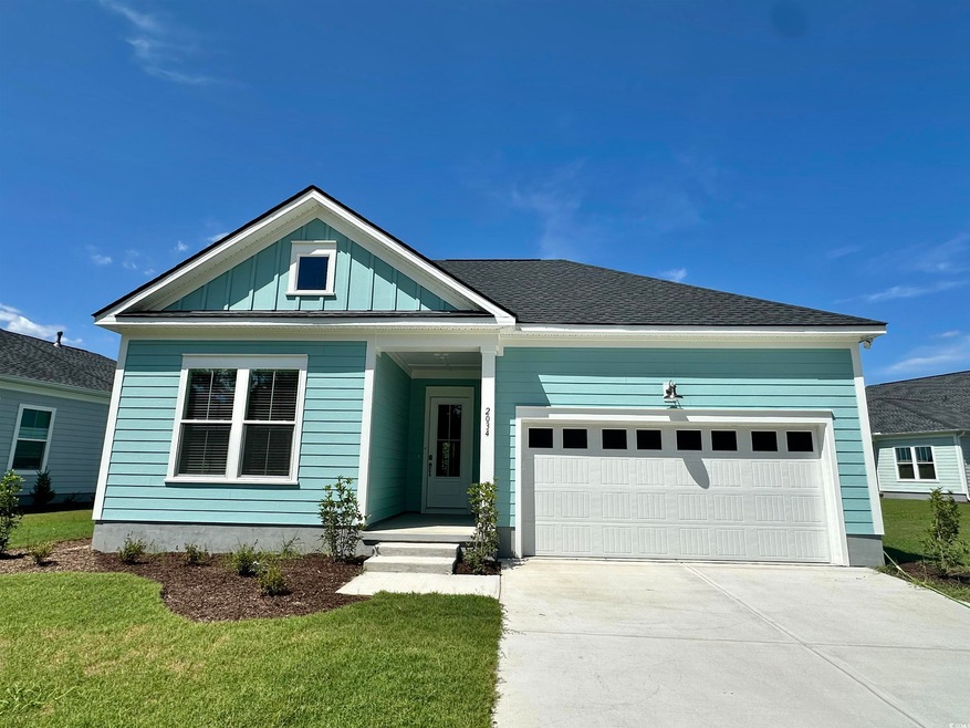View of front of home featuring a garage and a front lawn