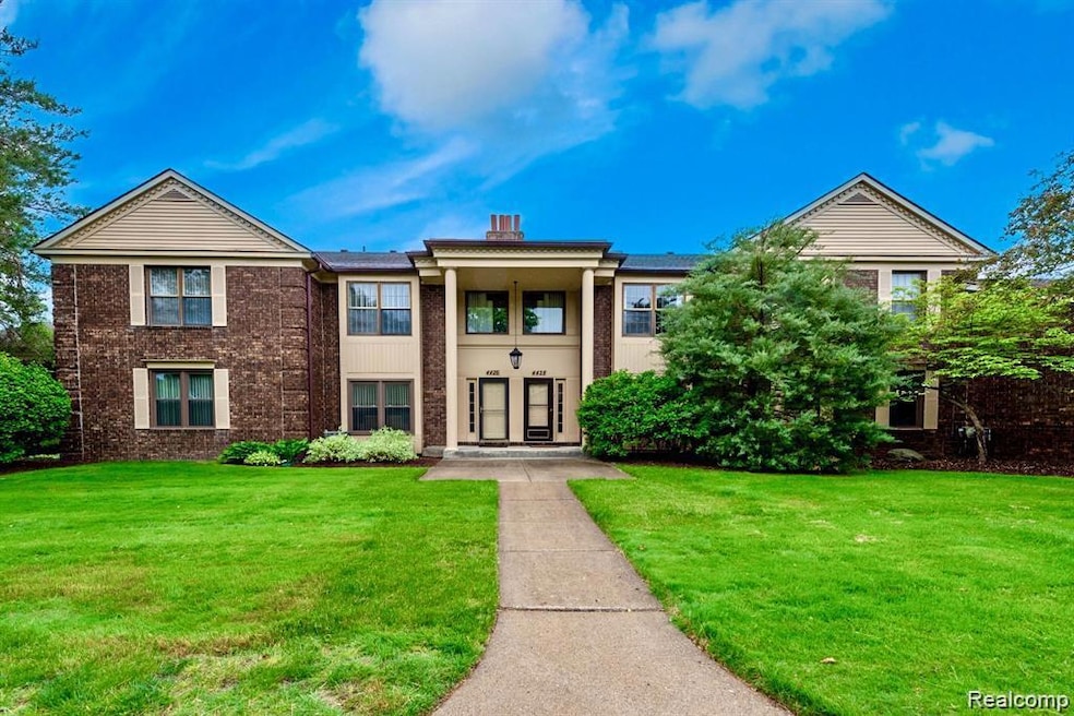 View of front of house featuring a front yard and brick siding