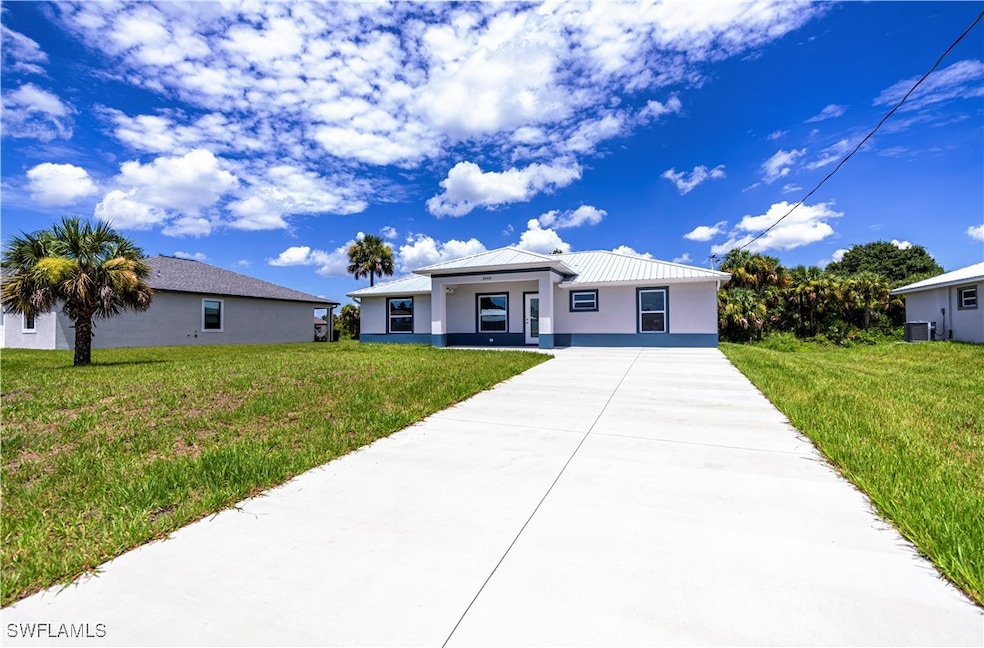 View of front facade with concrete driveway, metal