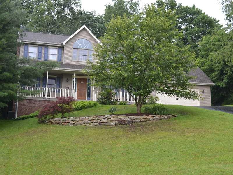 Exterior Front. Nicely landscaped home with paved 