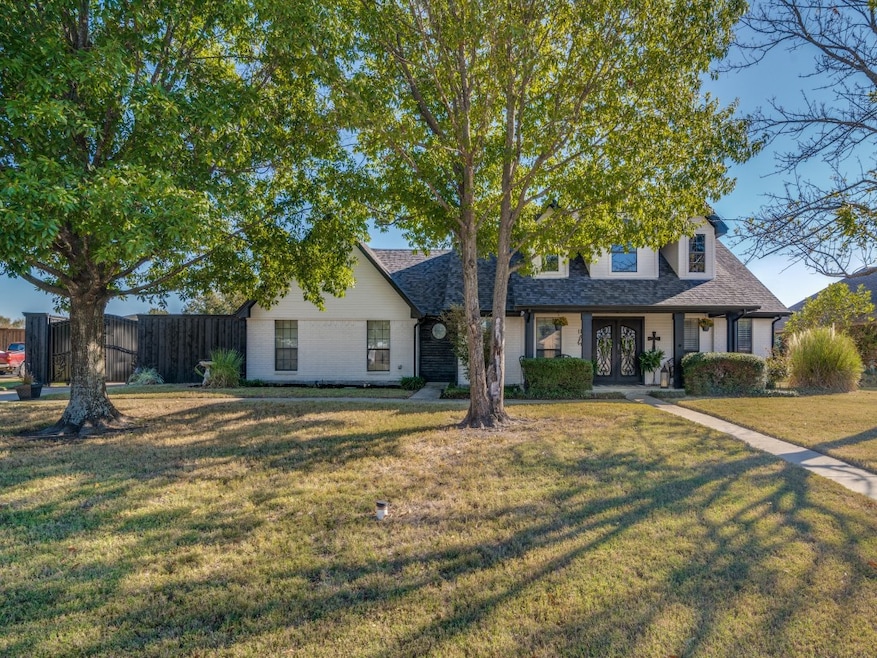 View of front of property featuring a porch, a shingled roof, and brick siding